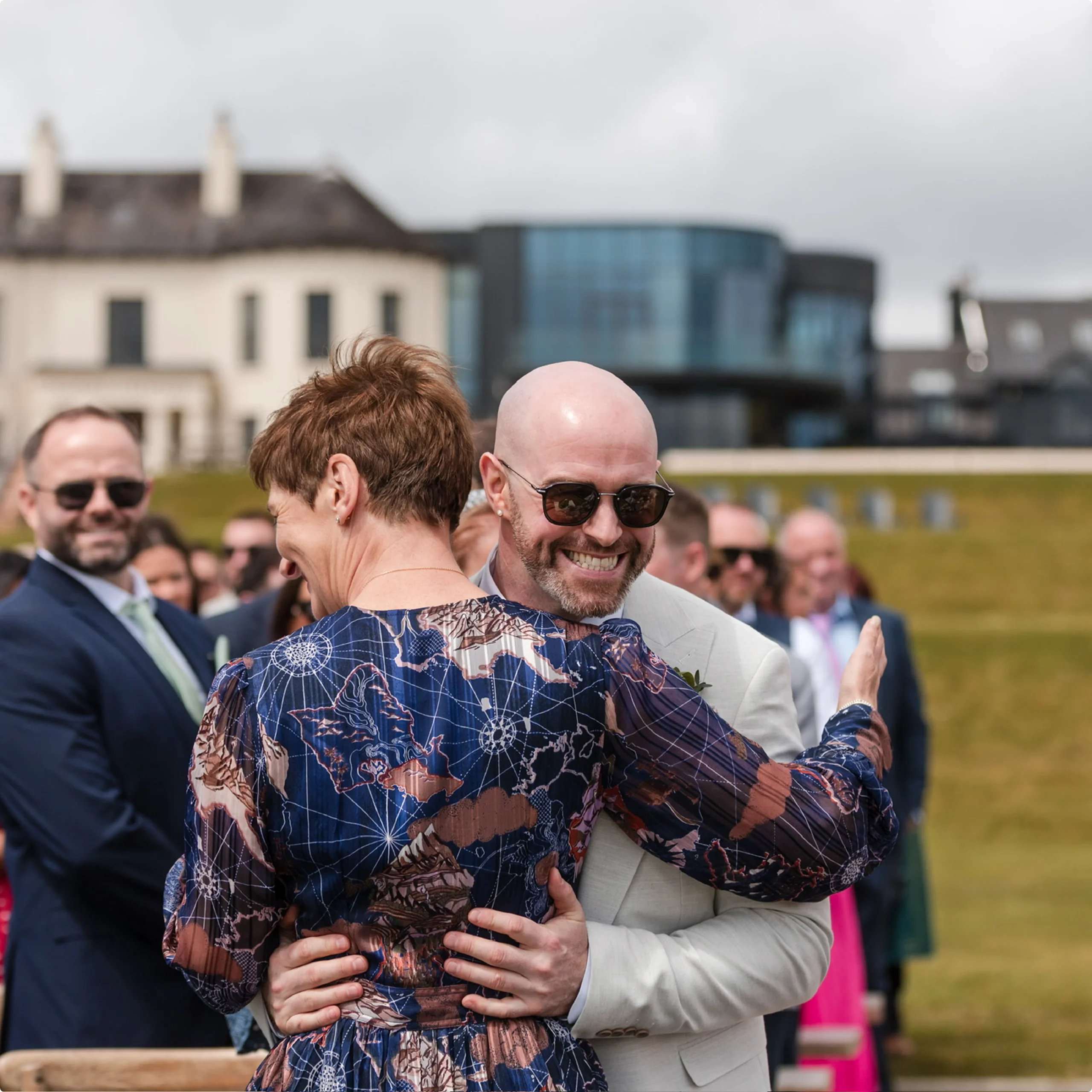 Rosemary Hartigan hugging the groom after an outdoor wedding ceremony