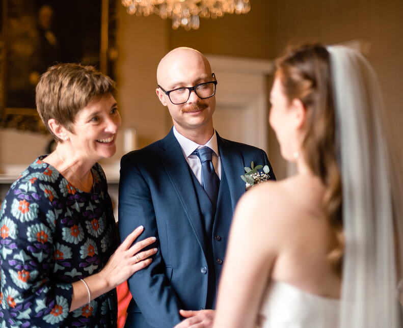 Rosemary Hartigan welcoming the bride and groom at the start of their ceremony