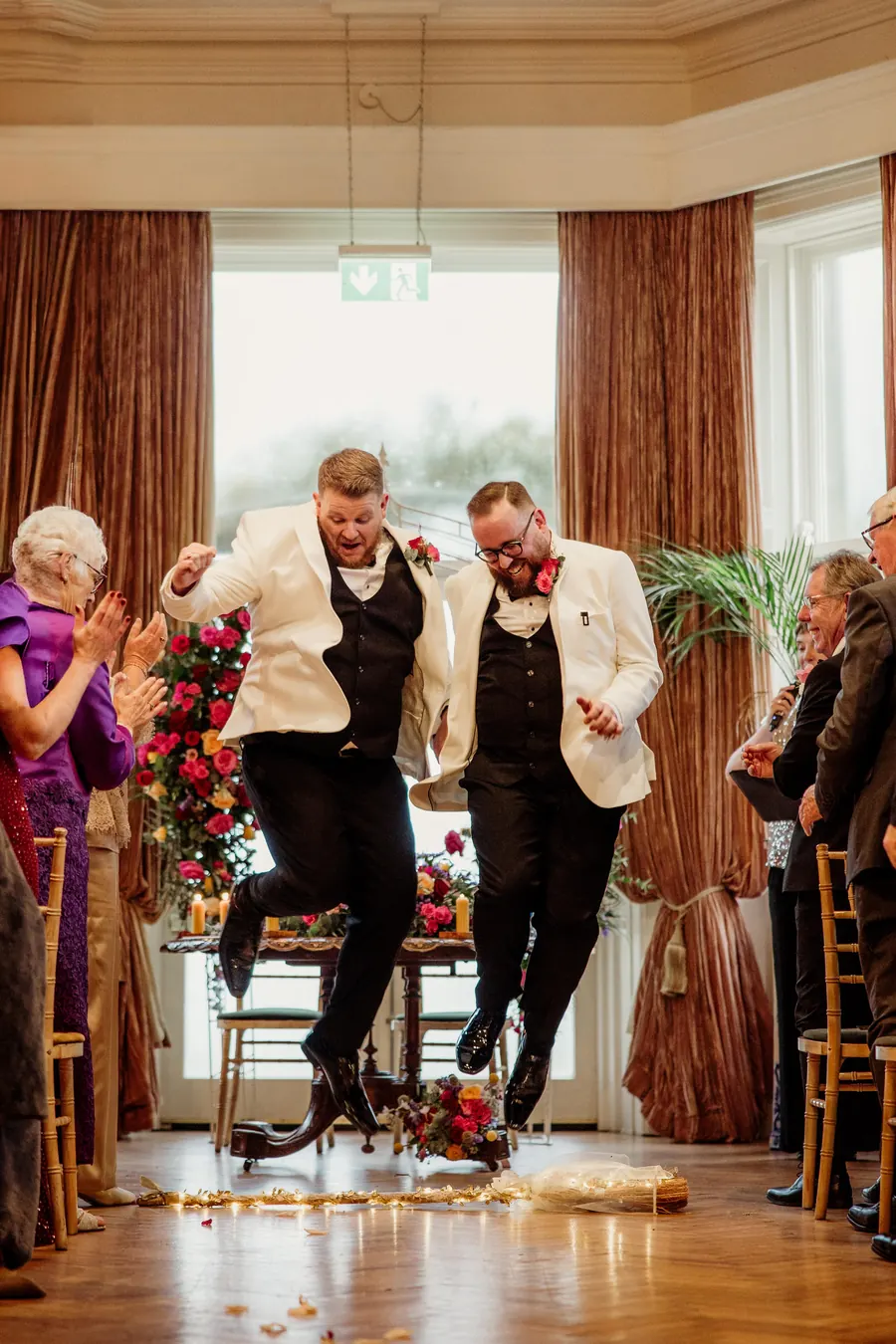 A couple jumping the broom at Tinnakilly House