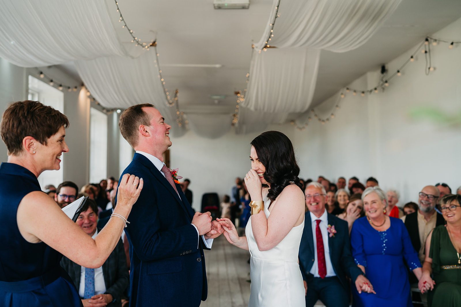 Rosemary Hartigan laughing with Ruth and Matthew during their wedding ceremony at Horetown House, Wexford